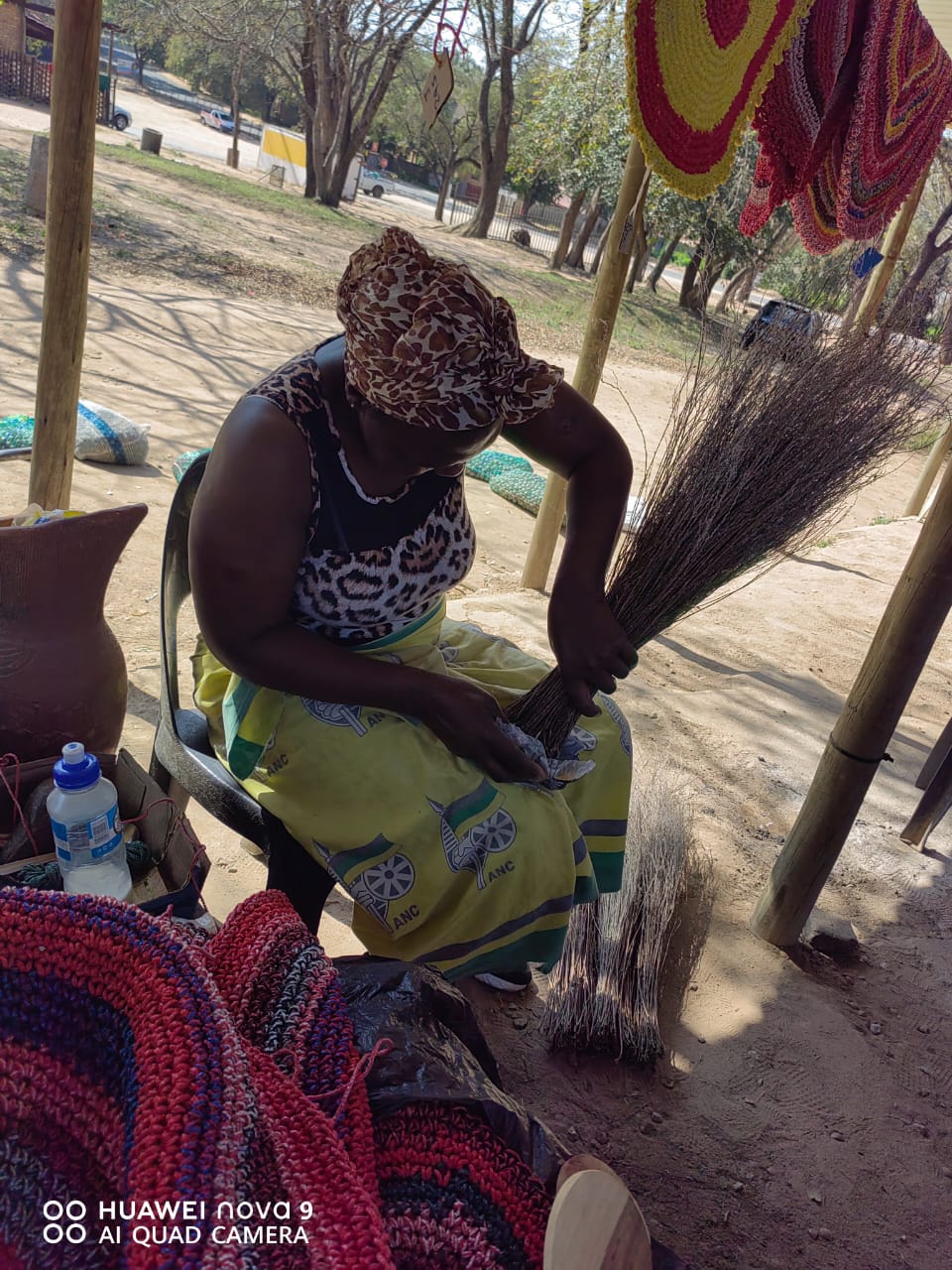 An artisan binding a traditional grass broom