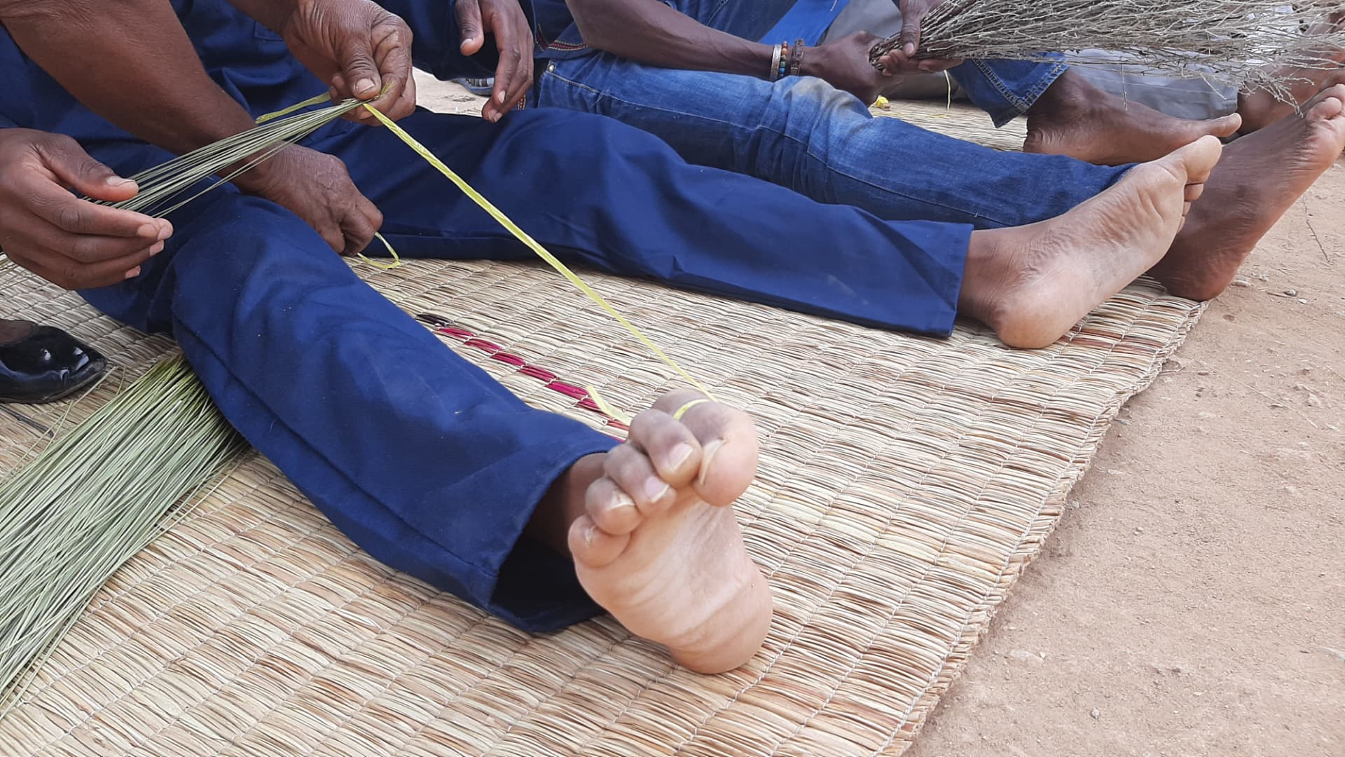Weaving a grass mat by hand